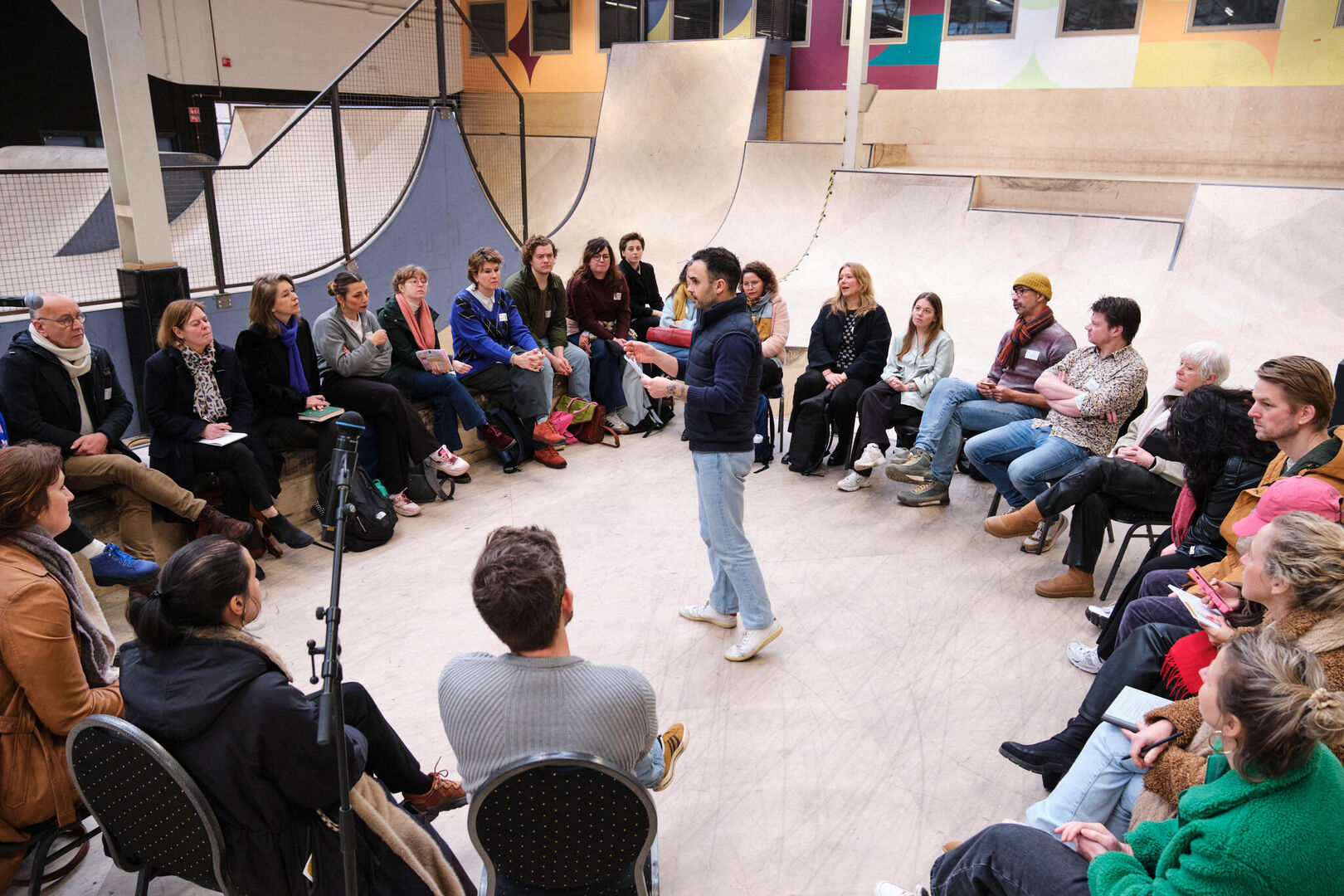 deelnemers luisteren in een kring naar Deniz